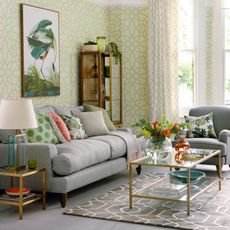 Living room with green trellis wallpaper and grey sofa