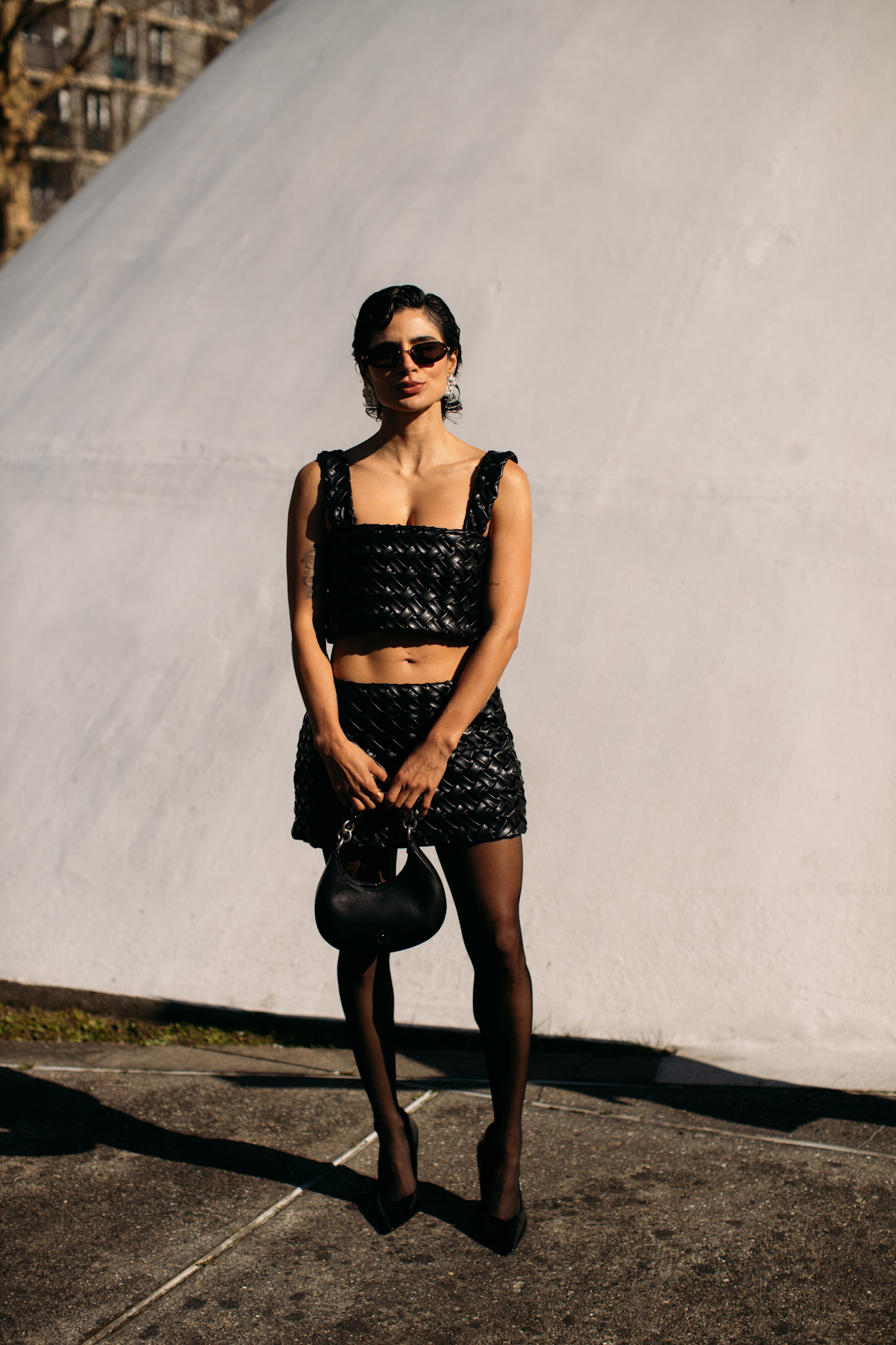 woman wearing crop top, mini skirt, sheer tights