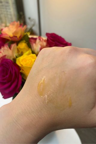 A smear of Q+A Caffeine eye serum on the back of a hand