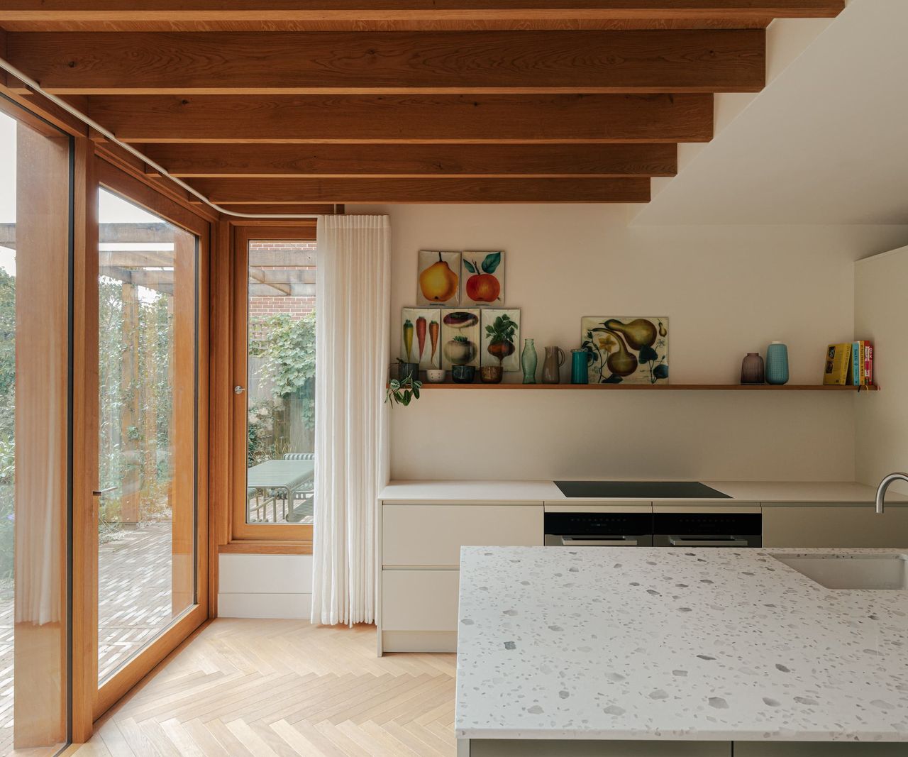 A timber extension with a marble kitchen island and white worktops