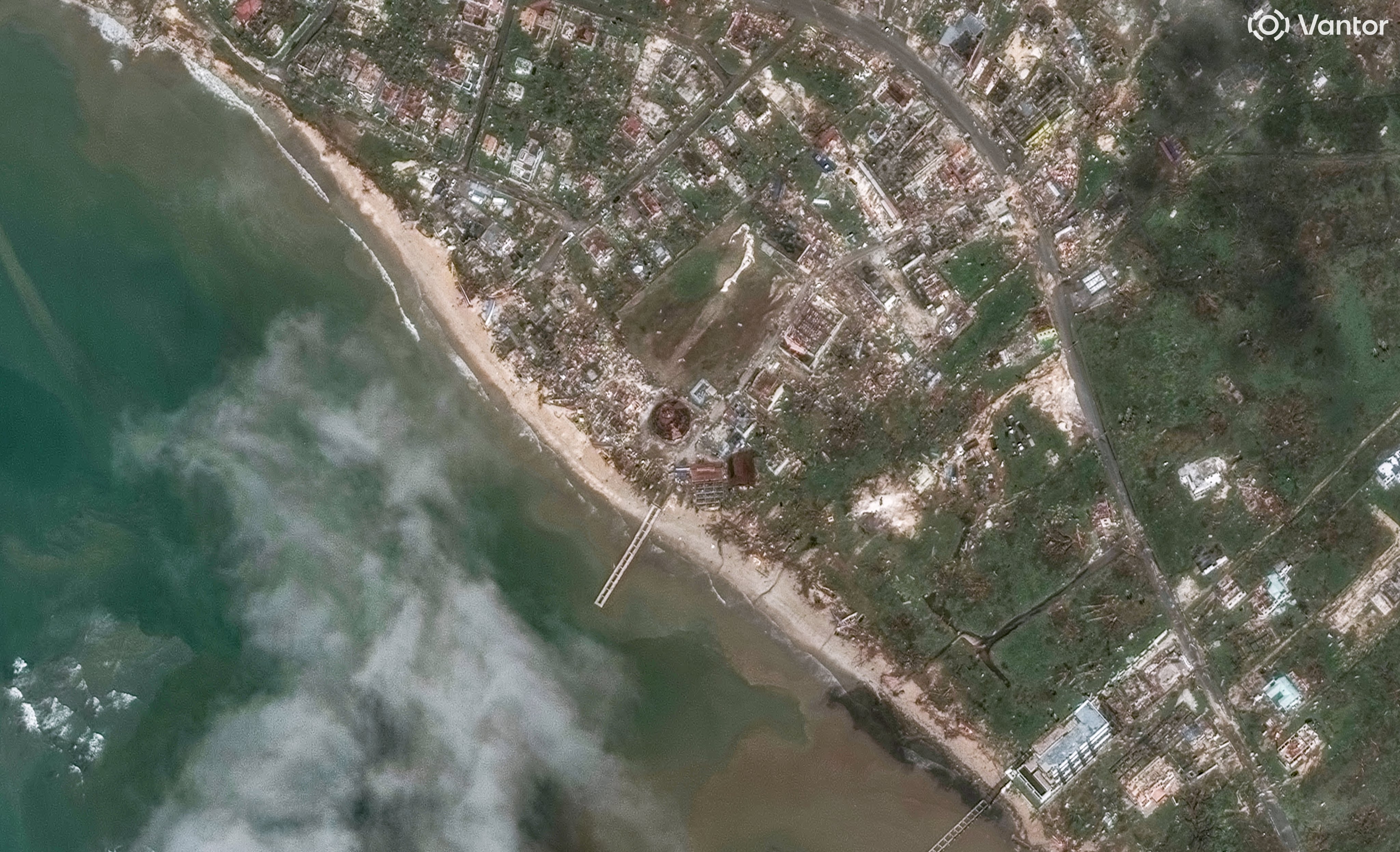 A series of satellite images from space showing the coastline of Jamaica with city blocks in ruins