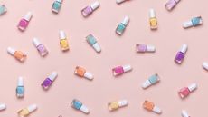 An assortment of pastel-colored nail polish paints on pink background