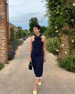 Woman wearing black and white dress at Soho Farmhouse.