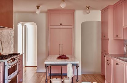 pink kitchen with a metal table
