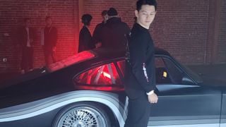 Man standing next to a Porsche