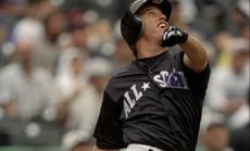 John Elway swings at a pitch during a 1998 All-Star Home Run Derby, which, really, is unfair considering the quarterback almost played professionally.