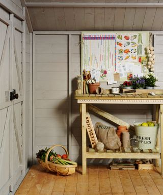 Wooden storage ideas for garden sheds, with freshly picked fruit and vegetables in a pale gray scheme.