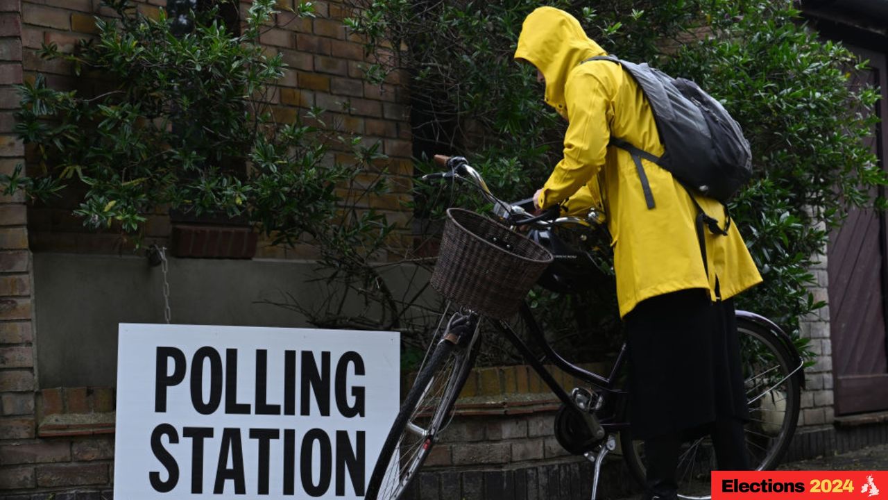 Voter heads to polling station in the rain for UK election.