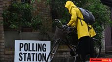 Voter heads to polling station in the rain for UK election.