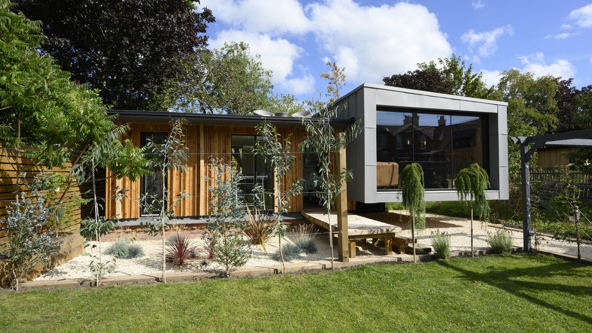 zinc and timber house built in a garden plot