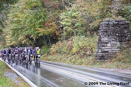 On the start of day three, racers head down Hwy 276 passing the historic entrance to Pisgah National Forest in Brevard, North Carolina.