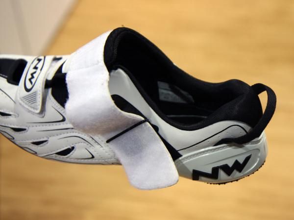 The large, reversed strap on the Northwave Tribute can be left open without snagging on crankarms for faster transition while a small Velcro tab helps hold them in that position, too.