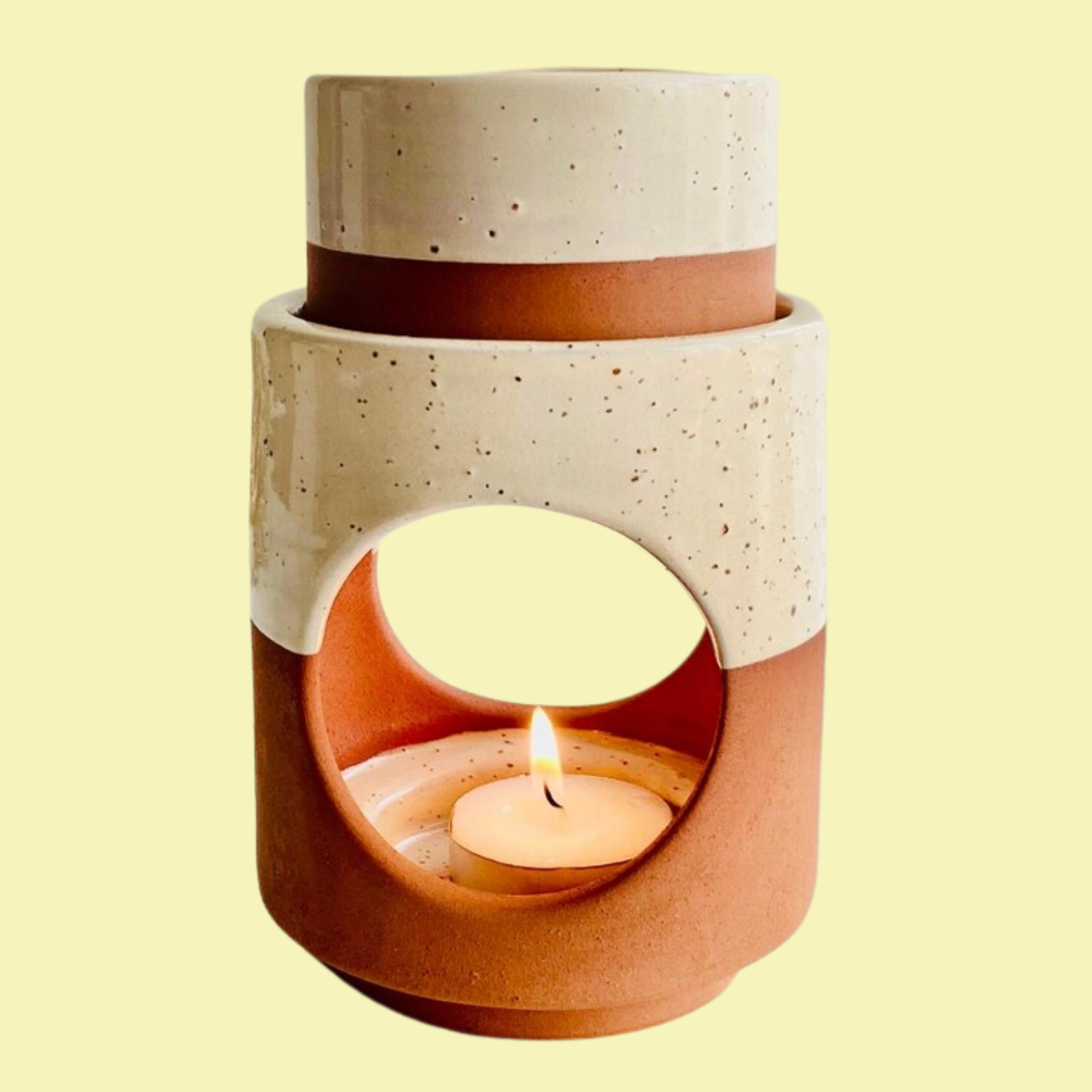 A speckled cream tealight essential oil burner