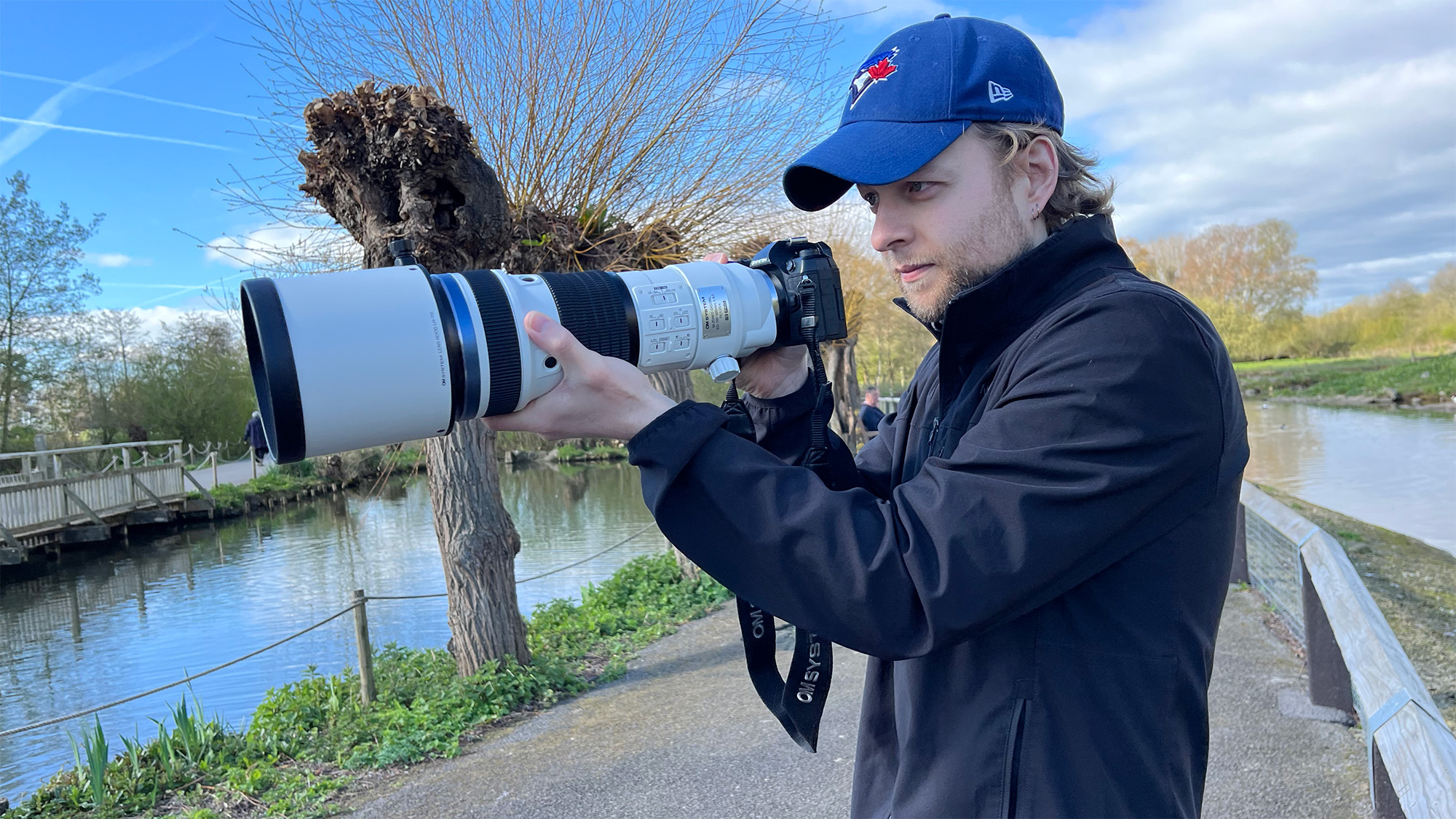 Mike Harris holding OM System M.Zuiko 150-400mm f/4.5 TC1.25x IS PRO at Slimbridge Wetland Centre