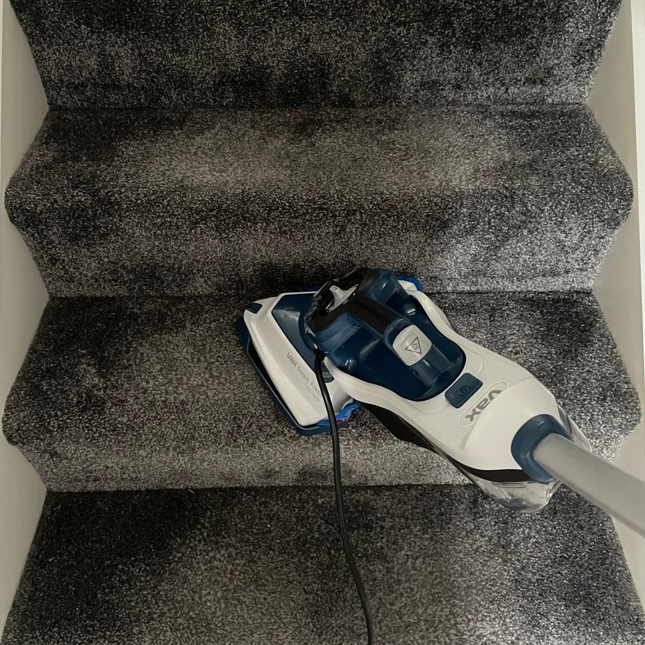 VAX Total Home Steam Cleaner cleaning grey carpeted stairs