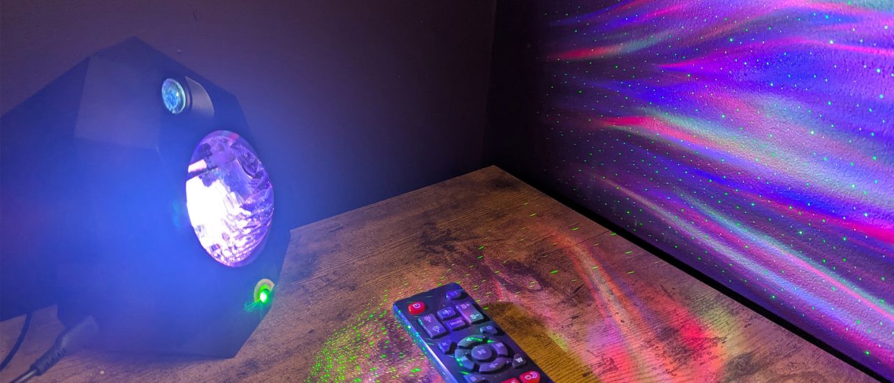 Cadrim Star Projector on a desk projecting lights onto the wall