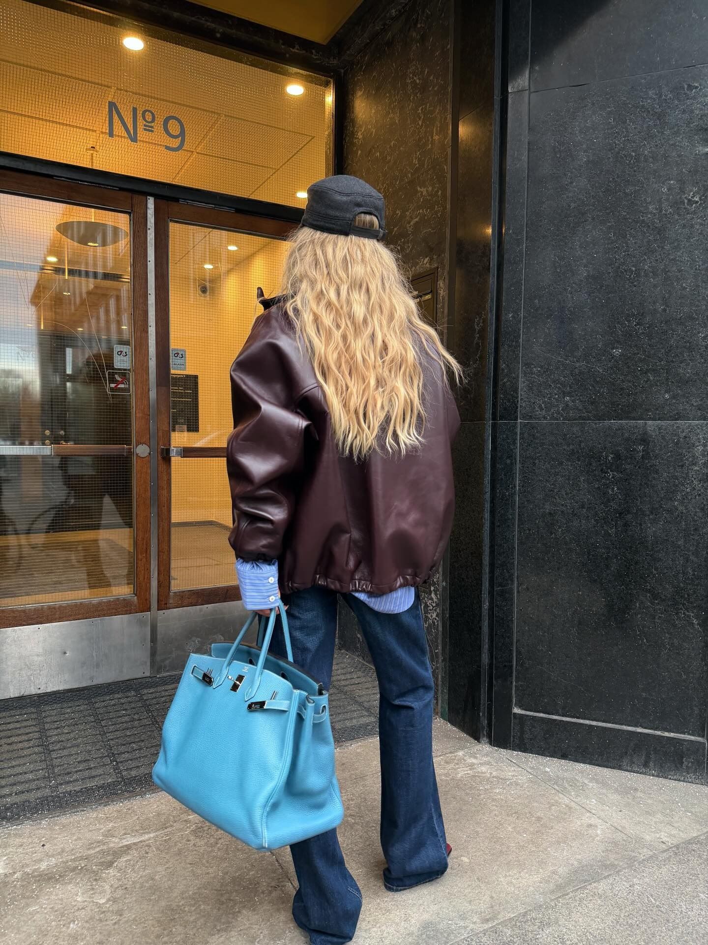 Woman wearing colorful handbag, a 2026 trend.