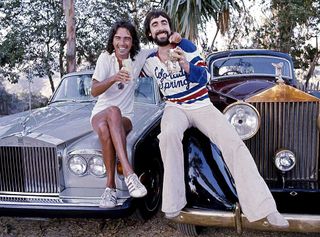 Alice Cooper and Keith Moon sitting on the hood of a Rolls Royce