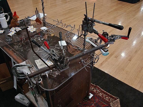 King stainless and tubular titanium cages are bent on this assembly line-style jig.