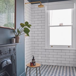 Bathroom with white subway tiles in shower and black fireplace