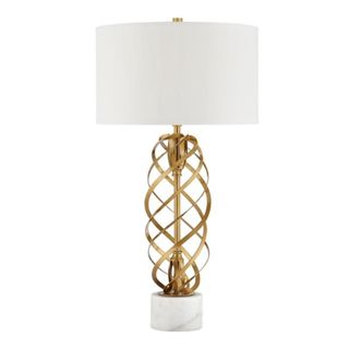 A lamp with a white lampshade and gold woven base