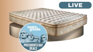 The Saatva Classic mattress shown on a gold plinth, with a blue Tom's Guide Presidents' Day deal badge overlaid on the bottom of the mattress. A LIVE badge is located in the top-right foreground. 