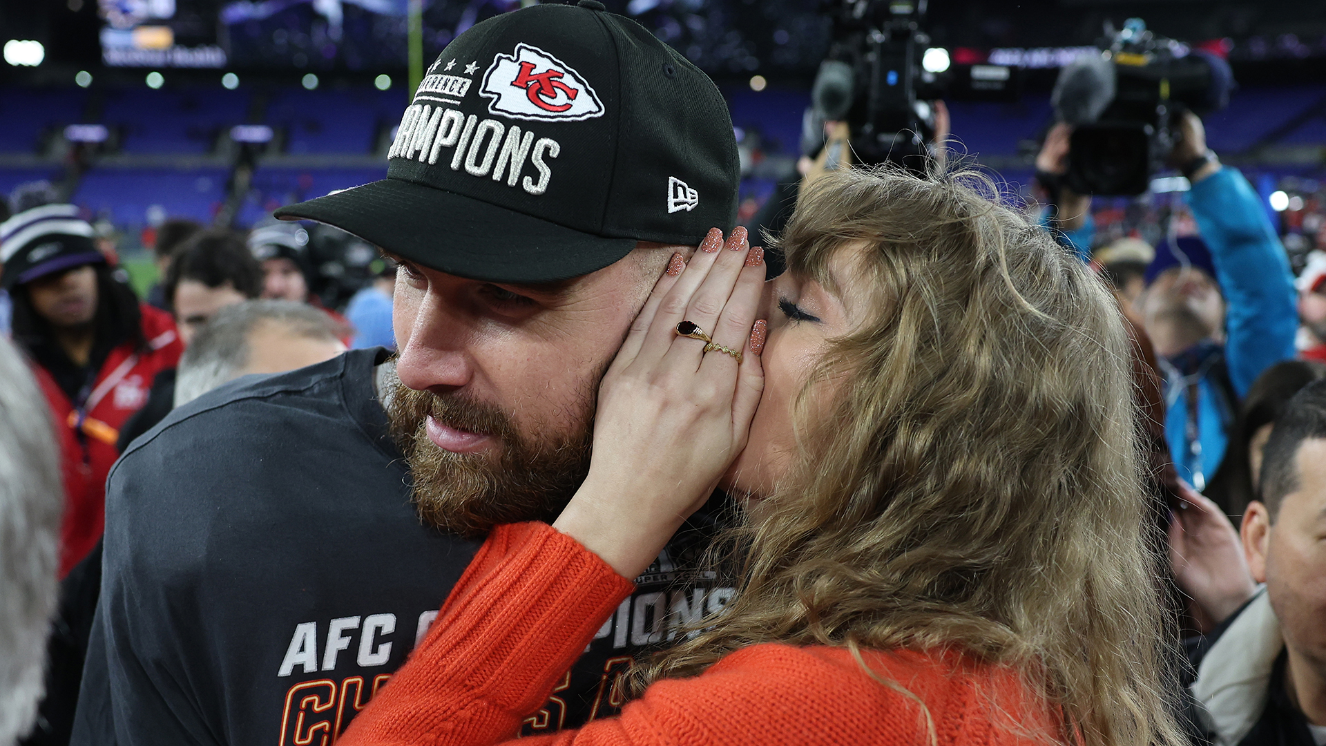 BALTIMORE, MARYLAND - JANUARY 28: Travis Kelce #87 of the Kansas City Chiefs celebrates with Taylor Swift as she whispers in his ear after a 17-10 victory against the Baltimore Ravens in the AFC Championship Game at M&amp;T Bank Stadium on January 28, 2024 in Baltimore, Maryland. (Photo by Patrick Smith/Getty Images)