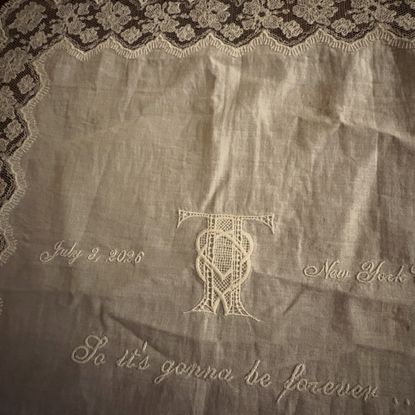 Maren Morris shares a souvenir from Taylor Swift and Travis Kelce's wedding, which is a white embroidered doily napkin featuring lyrics from Blank Space