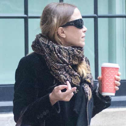 Mary-Kate Olsen was spotted in New York City wearing a velvet coat, Adidas sneakers, and a croc The Row bag