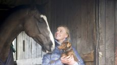 Georgie Campbell looks adoring at her horse while holding her dog Twig in her arms. The foundation prize draw aims to raise money for a programme set up in Georgie&rsquo;s memory.