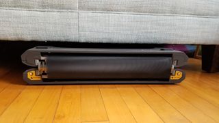 A photo of the WalkingPad P1 under the couch