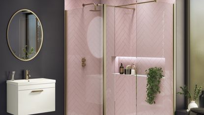 shower room with pink tiles, black walls and and gold finishings 
