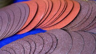 An array of different grade sandpaper discs
