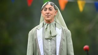 Alan wearing a green ensemble on The Traitors. 