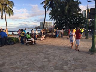 On the south shore of Oahu, hundreds of people spread out in small groups along Waikiki beach to take in the sight of the solar eclipse on Aug. 21, 2017.