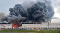 a Russian warehouse on fire after being hit by a drone