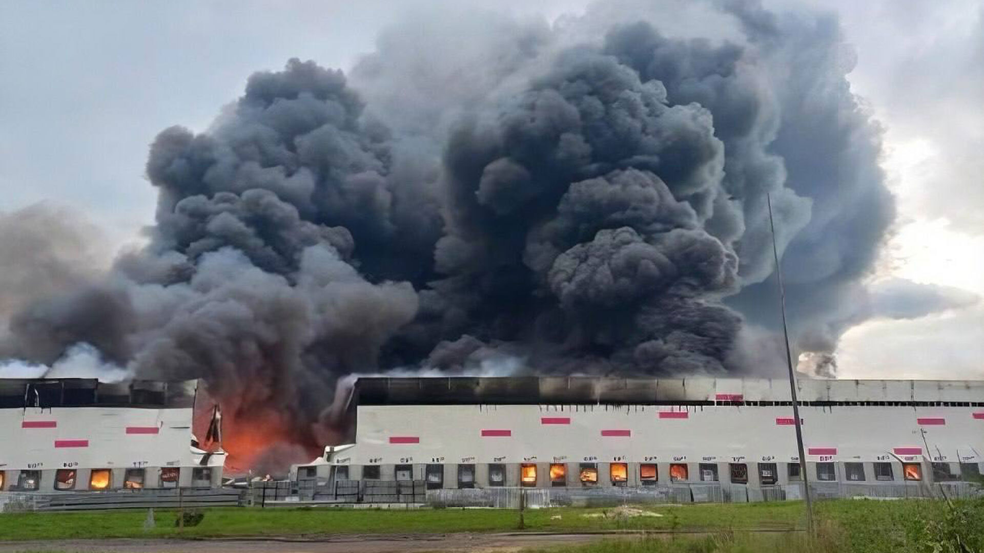 a Russian warehouse on fire after being hit by a drone