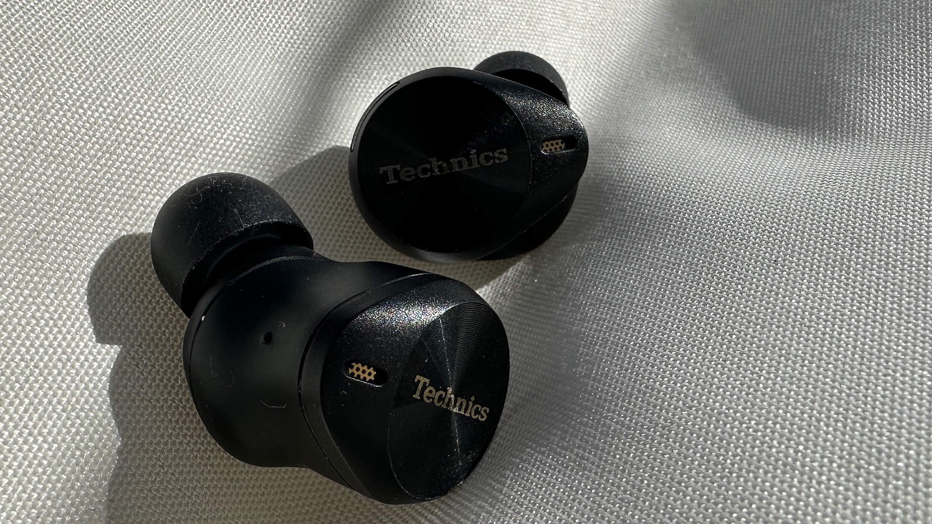 The Technics EAH-AZ80 earbuds outside their case