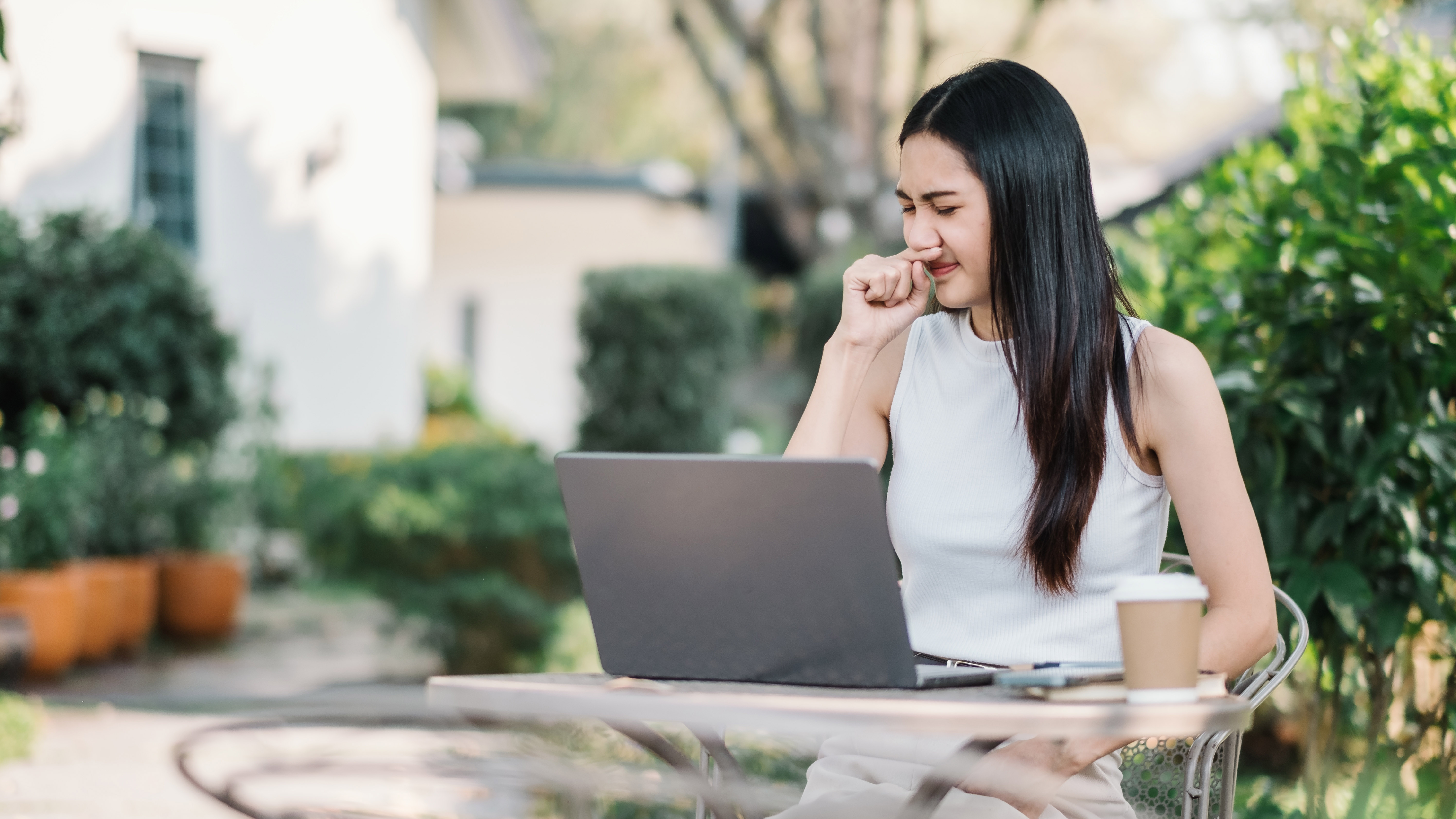 Woman smelling something bad in her yard