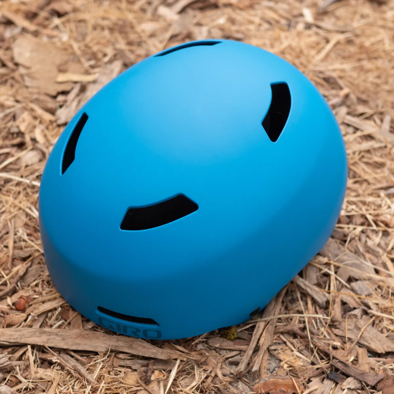  Giro Dime MIPS kids helmet in blue on the ground 