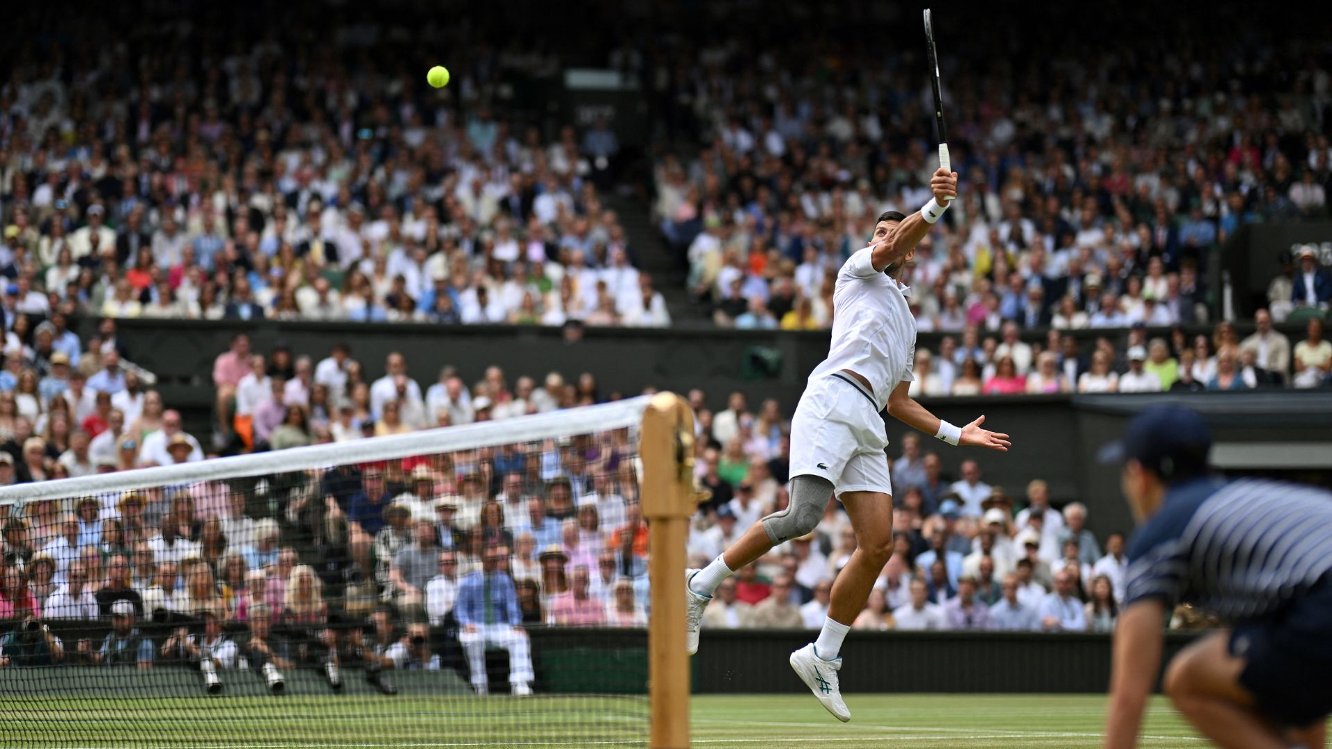 Serbia's Novak Djokovic returns against Spain's Carlos Alcaraz during their men's singles final tennis match on the fourteenth day of the 2024 Wimbledon Championships at The All England Lawn Tennis and Croquet Club in Wimbledon, southwest London, on July 14, 2024