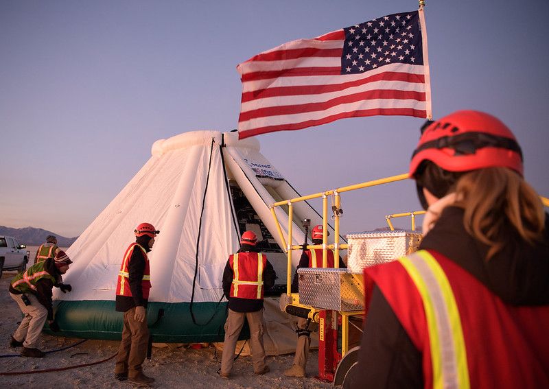 Boeing, NASA, and U.S. Army personnel work around the Boeing CST-100 Starliner spacecraft shortly after it landed in White Sands, New Mexico, Sunday, Dec. 22, 2019.