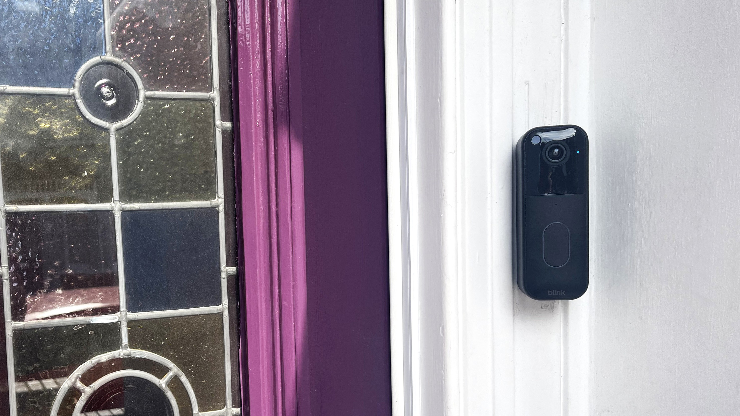 Blink Video Doorbell Gen 2 mounted beside purple door