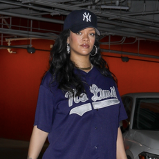 Pregnant pop star Rihanna wears sweatpants and a baseball jersey with a chanel bag and gucci pointe shoes.