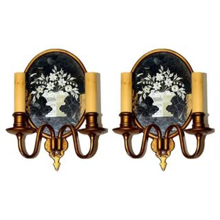 Two vintage sconces with painted floral detailing 