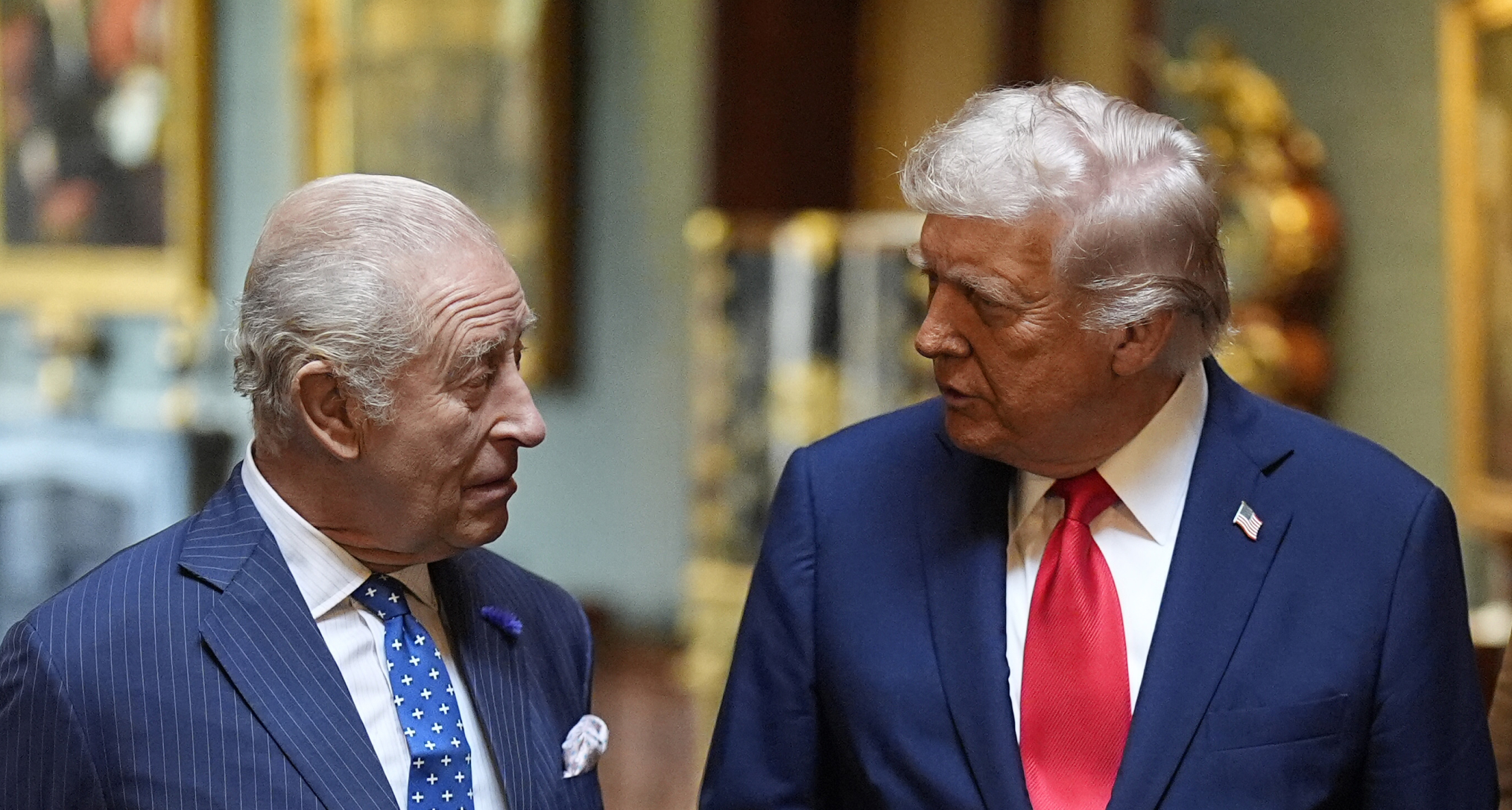 King Charles and Donald Trump wearing suits and ties looking at each other