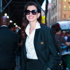 Anne Hathaway in New York City wearing a blazer jeans and a bulgari watch