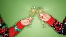Two women's hands cheers with glass of alcohol