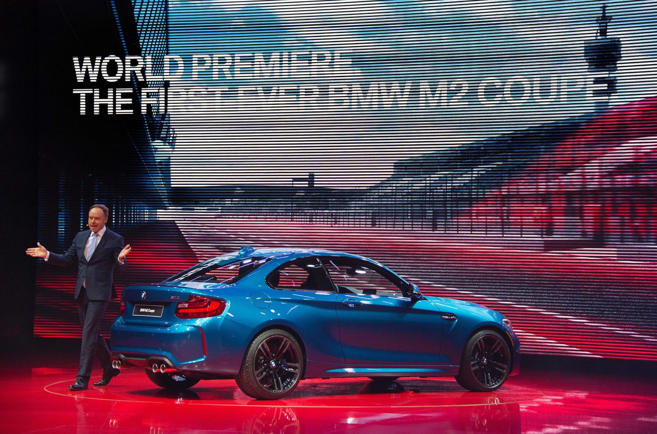 BMW's director for sales and marketing Dr. Ian Robertson (L) unveils the 2016 BMW M2 Coupe during the BMW press conference at the North American International Auto Show in Detroit, Michigan,