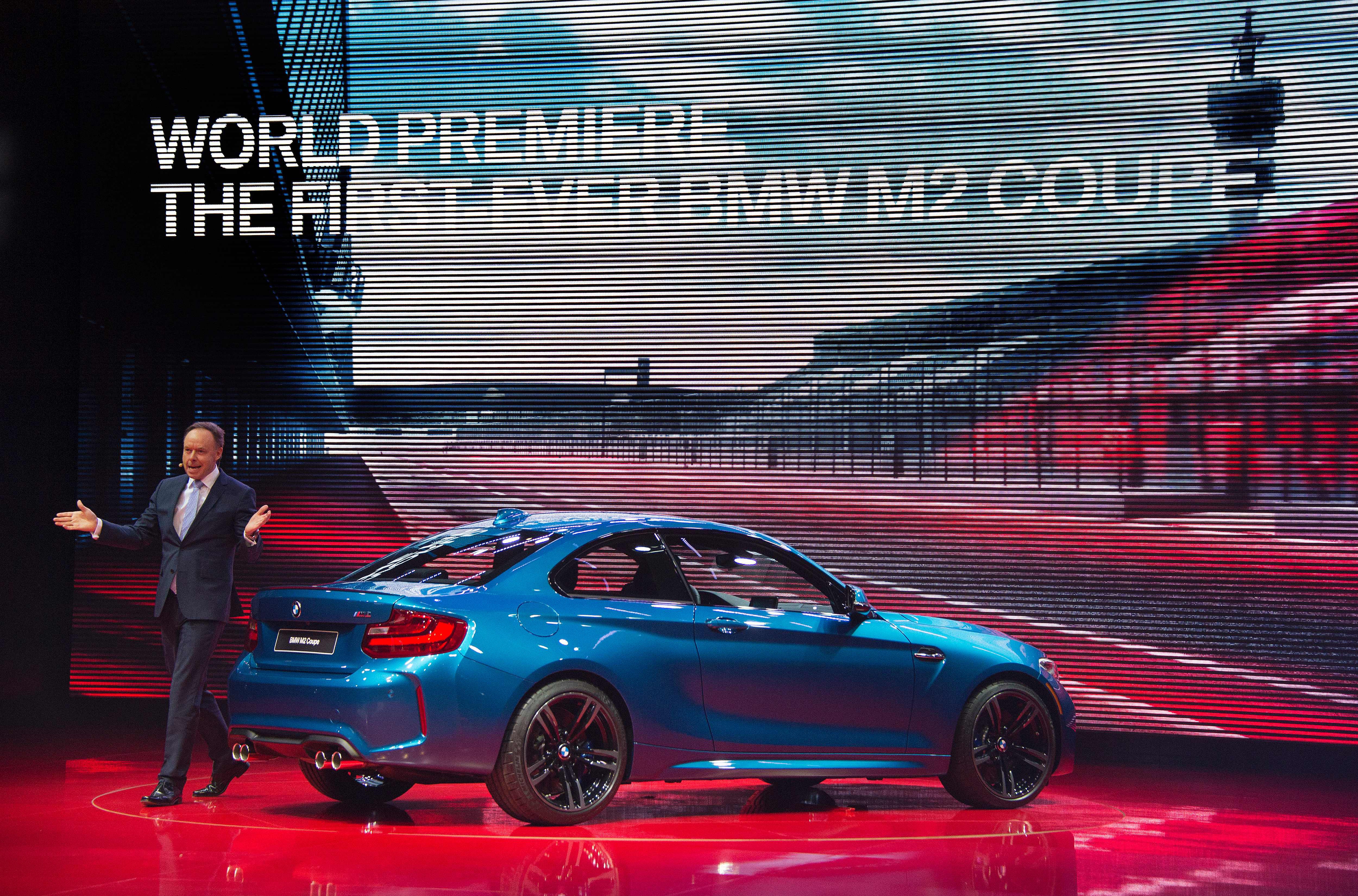 BMW's director for sales and marketing Dr. Ian Robertson (L) unveils the 2016 BMW M2 Coupe during the BMW press conference at the North American International Auto Show in Detroit, Michigan,